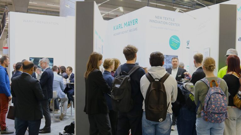 Visitors exploring KARL MAYER textile technologies